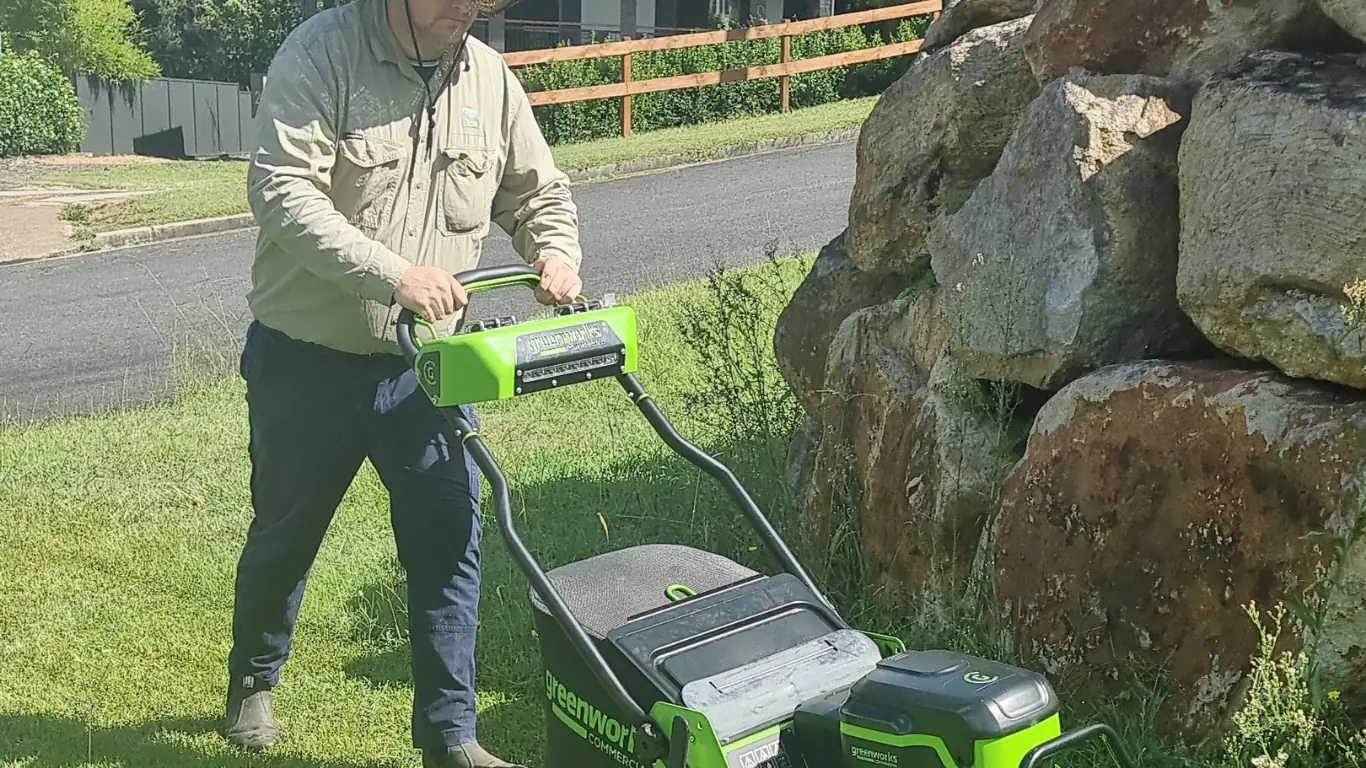 John from Beg Your Garden mowing a Raceview lawn