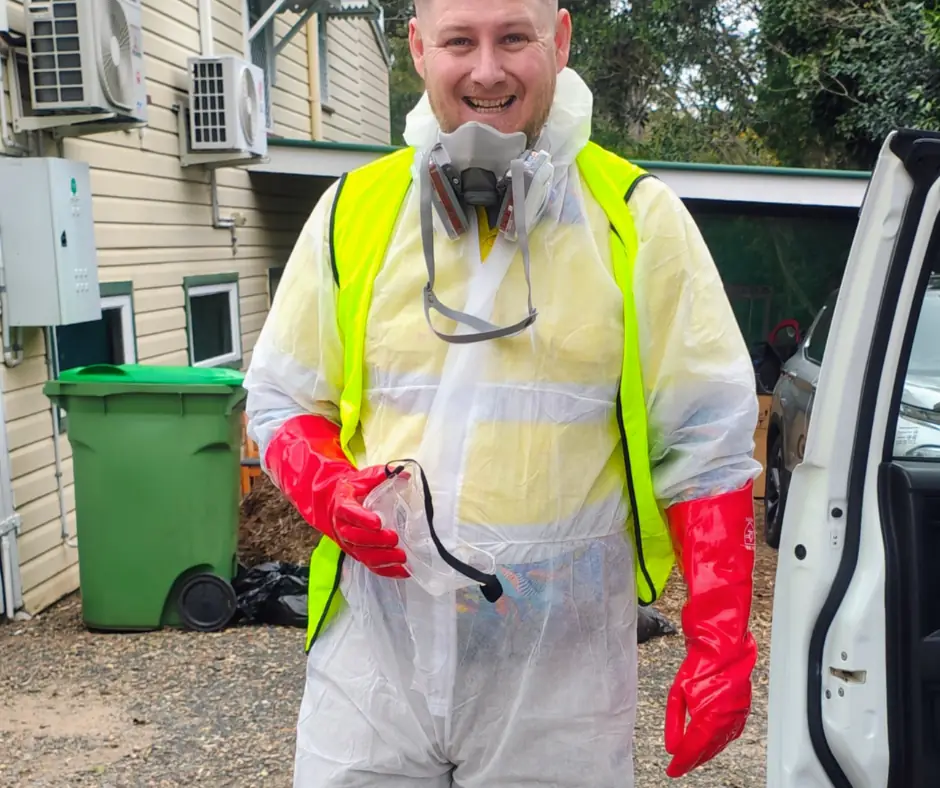Lawn fertilising and weed control Ipswich: Beg Your Garden technician in PPE ready for herbicide application